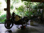 A little light bike maintenance in a teak garage